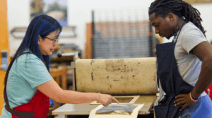 Art professor Tammy Harrington working with a student on an art project