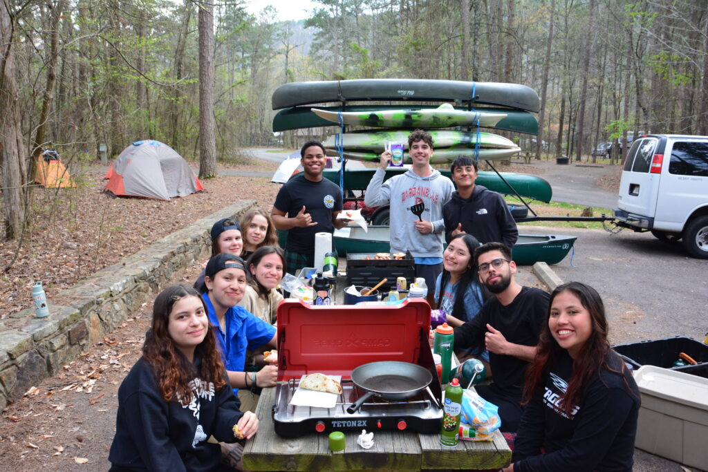 Student eating on an Ozarks Outdoors Camping trip