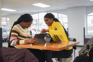 Students in the the Student Center on their iPads.