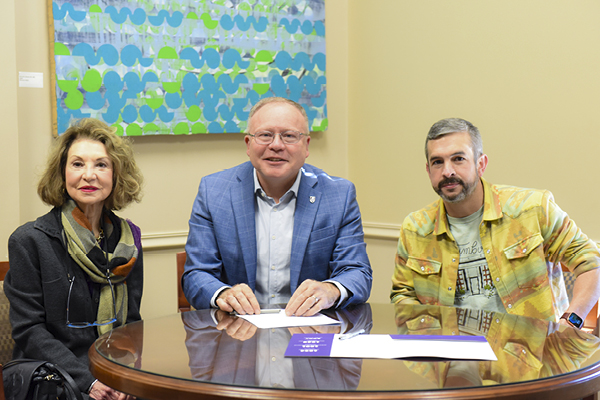 Blaake Owen '06 and mother sign scholarship agreement