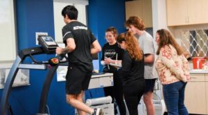 Students testing heart rates in class while running on treadmill